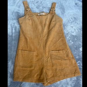 A medium sized tan corduroy romper/overall